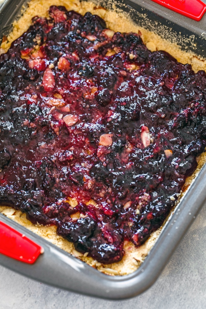 Almond bar base with blueberry jam spread on top.