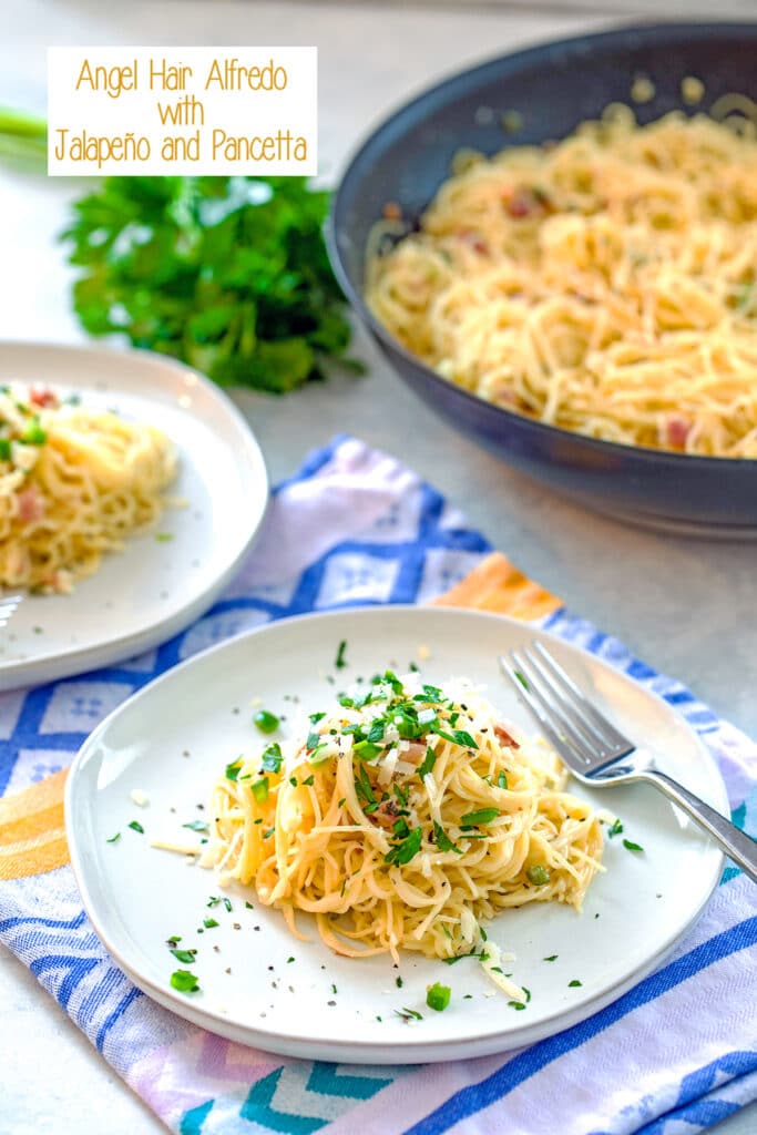 Plate of angel hair alfredo with jalapeño and pancetta with second plate, parsley, and skillet of pasta in background and recipe title at top of image