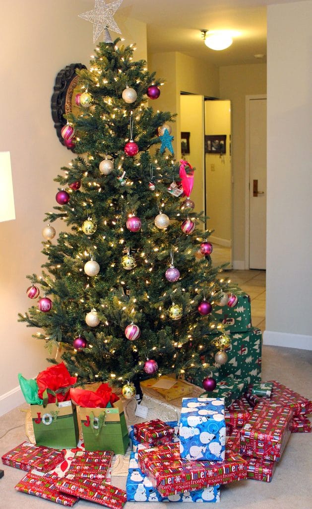 View of decorated Christmas tree with presents under it