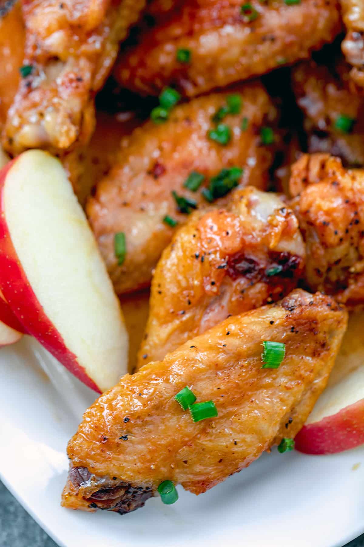 Close-up of an apple cider chicken wing on platter.