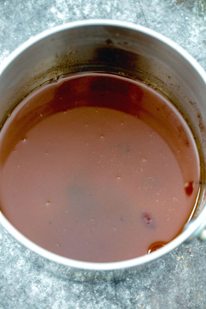 Apple cider sauce in saucepan