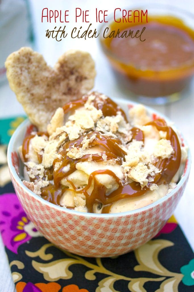 Head-on view of a bowl of apple pie ice cream drizzled with cider caramel and topped with a heart-shaped pie crust cookie with bowl of apple cider caramel in background and recipe title at top