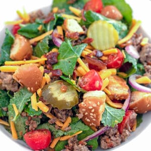 Bacon Cheeseburger Kale Salad -- This Bacon Cheeseburger Kale Salad is essentially a deconstructed bacon cheeseburger set over a bed of baby kale and topped with a "secret sauce" dressing. Totally customizable to your own preferences, this is way more fun than the average kale salad! | wearenotmartha.com #kale #salad #kalesalad #cheeseburger #bacon