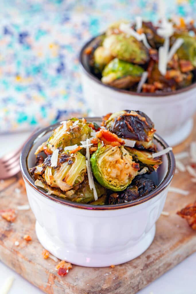 Bacon parmesan brussels sprouts in a small bowl with second bowl in background