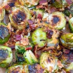 Overhead view of crispy bacon parmesan brussels sprouts on a baking sheet