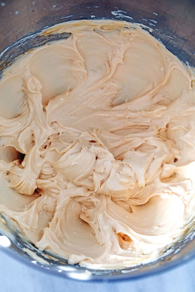 Overhead view of Baileys frosting whipped together in mixing bowl