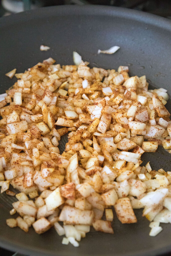 Onions and spices cooking in pan