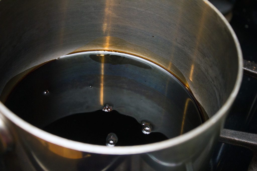 Overhead view of balsamic vinegar in saucepan in the process of thickening and reducing