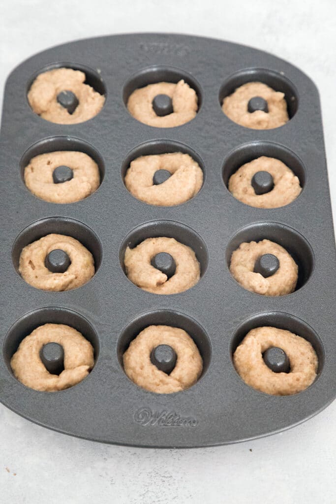 Donut batter piped into mini donut pan