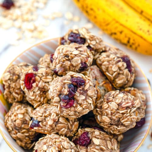 Banana Maple Cranberry Cookies -- These healthy Banana Maple Cranberry Cookies have a banana base and are packed with oats, flaxseed, applesauce, and dried cranberries. They're quick and easy to make and can double as dessert or breakfast! | wearenotmartha.com