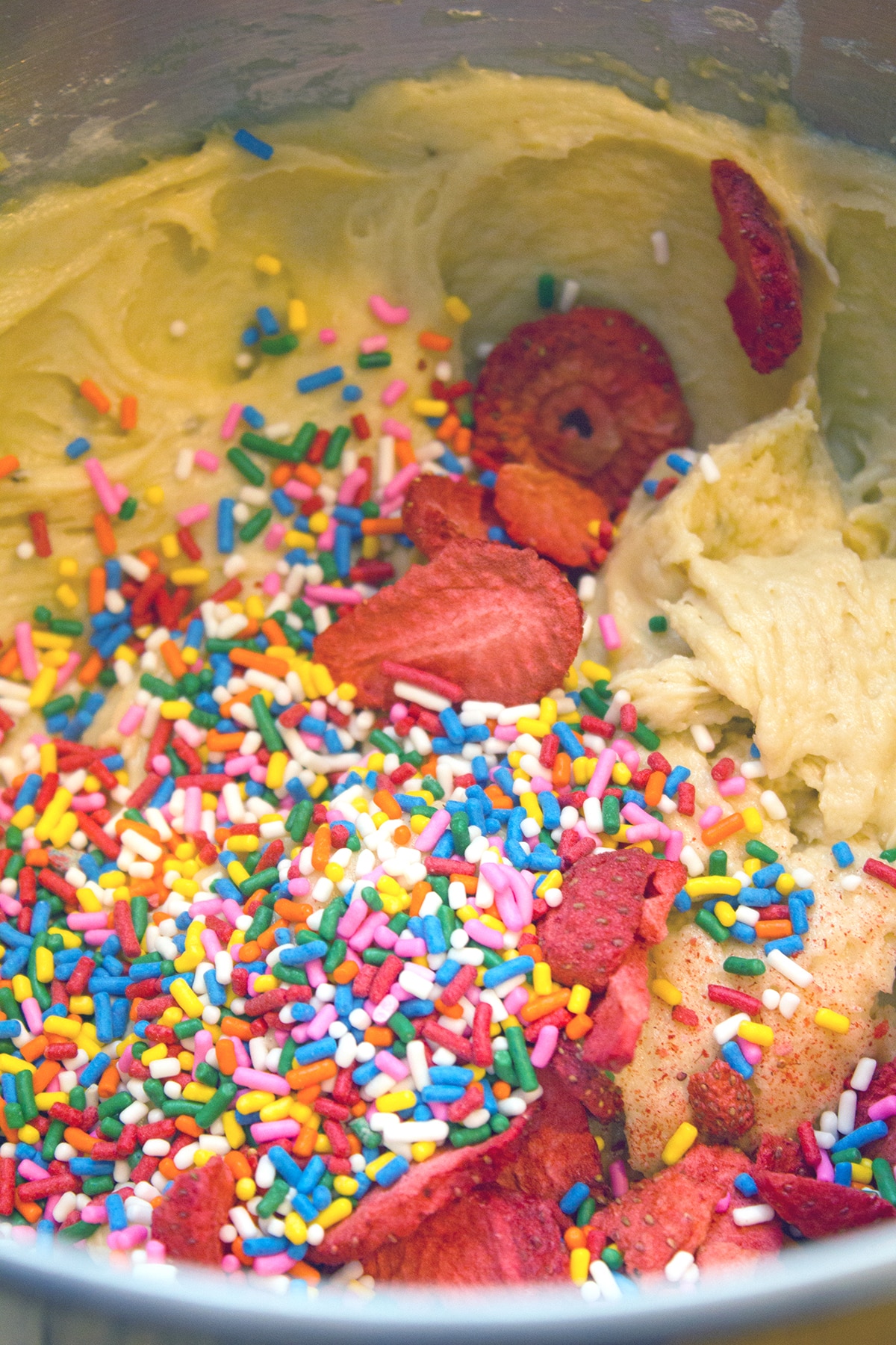 Banana split cookie batter with freeze-dried strawberries and rainbow sprinkles.