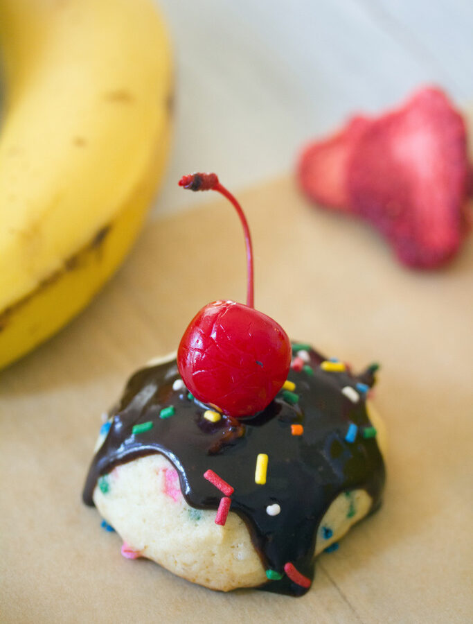 Banana Split Cookies -- Banana strawberry cookies with chocolate sauce, marshmallow, sprinkles, and a cherry on top! | wearenotmartha.com