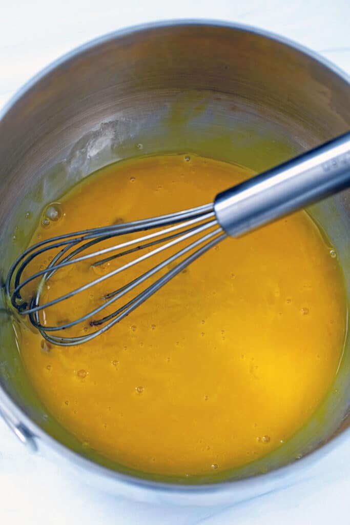 Egg yolks whisked together in small bowl.