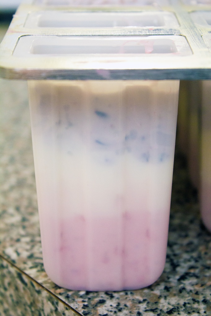 Image showing Berry Greek Cheesecake Popsicle molds with red, white, and blue layers