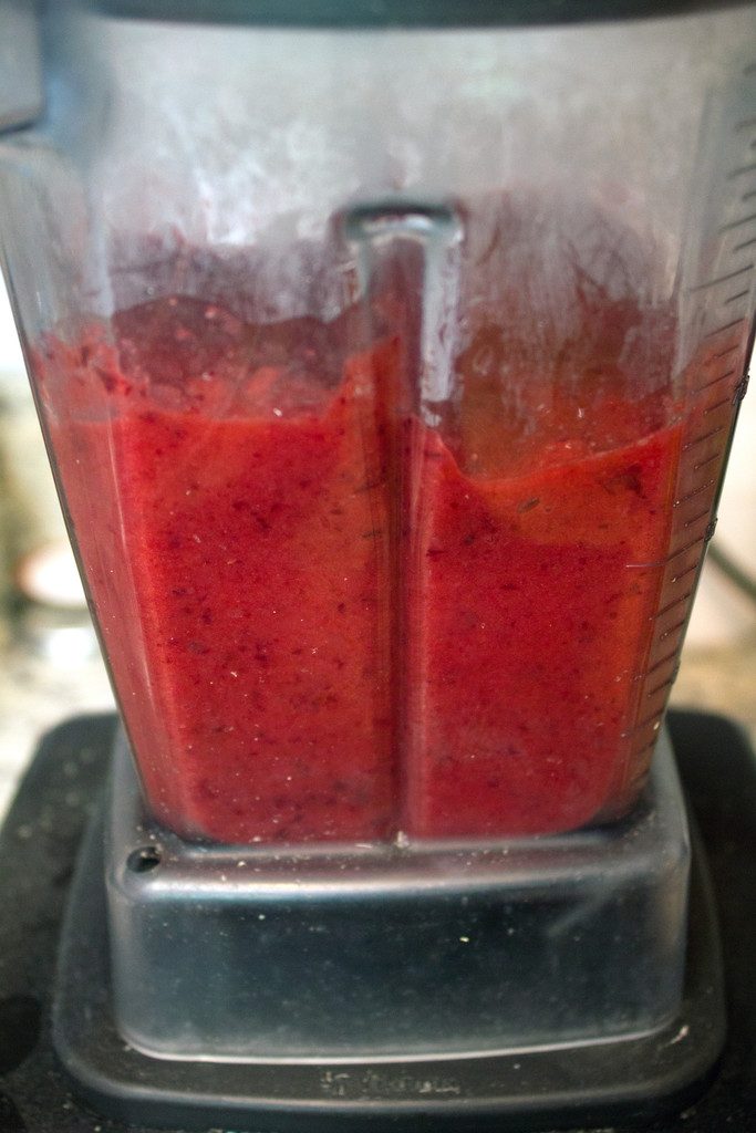 Head-on view of cherries pureed in a blender