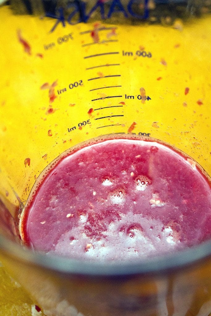 Freshly squeezed blood orange juice in a measuring cup