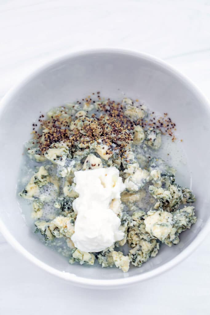 Blue cheese dressing ingredients in a small bowl