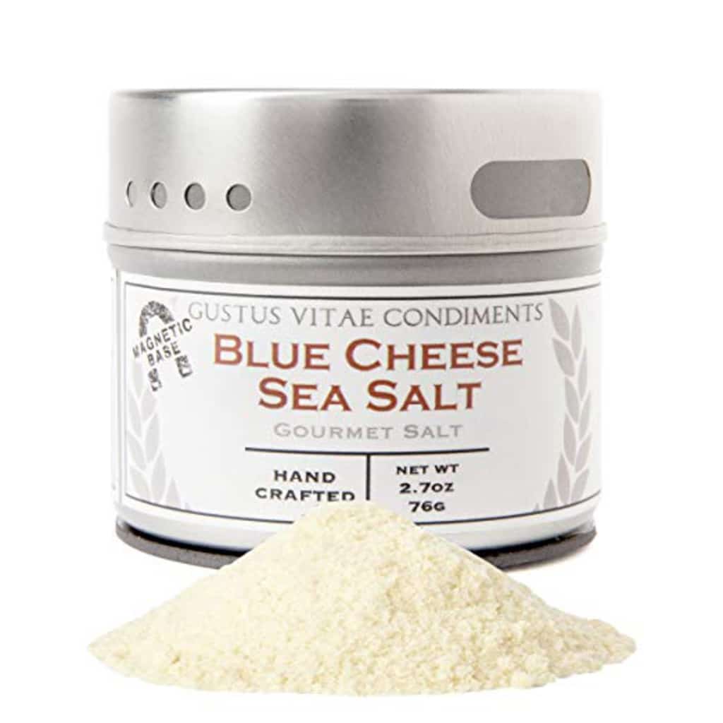 Head-on view of container or blue cheese sea salt with pile of salt in front of it