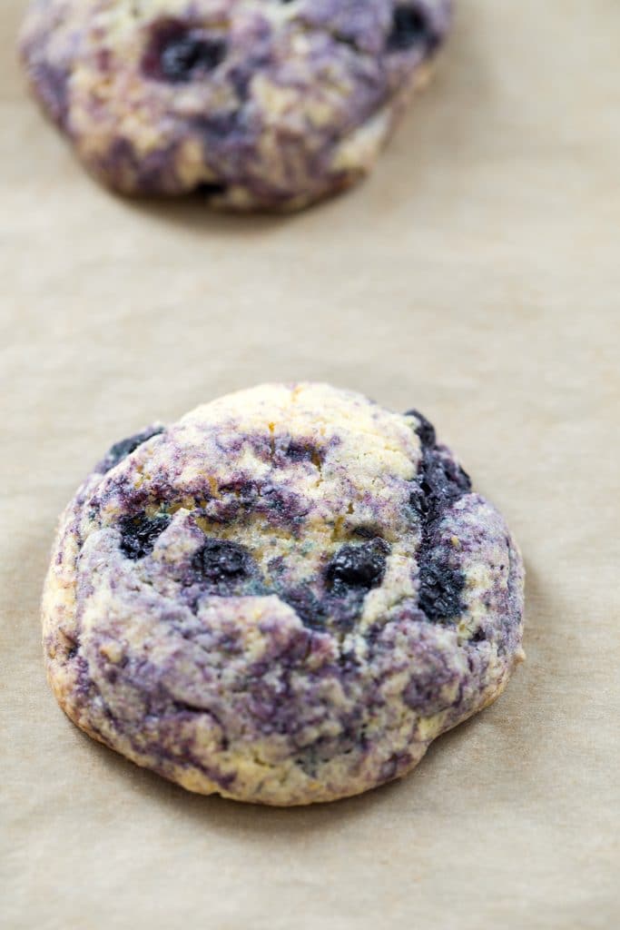 A closeup of a Blueberry Corn Toaster Cake on a parchment paper-lined cookie sheet