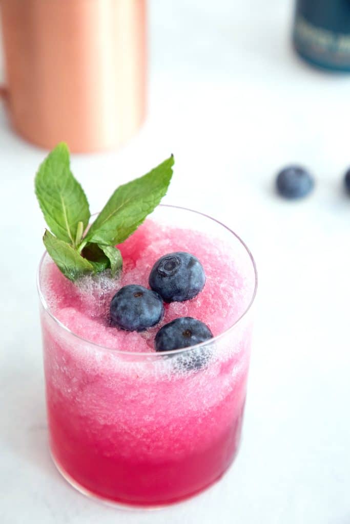 Blueberry Frozen Moscow Mules -- Ginger beer, vodka, and blueberry simple syrup are blended with crushed ice for this summertime frozen cocktail | wearenotmartha.com