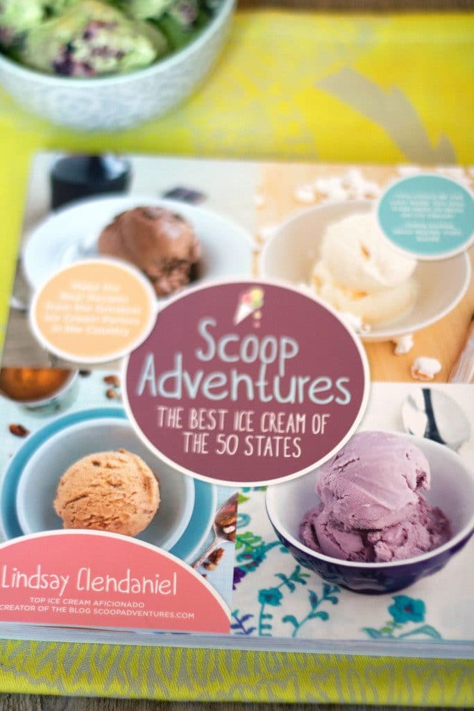 Overhead view of Scoop Adventures cookbook with bowl of ice cream in background