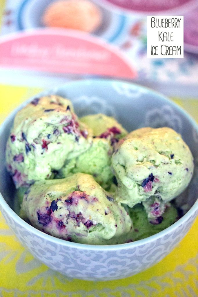 Overhead view of green blueberry kale ice cream in a bowl with cookbook in the background and recipe title at top