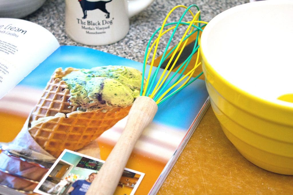 Scoop Adventures cookbook open on the counter with a whisk and mixing bowl