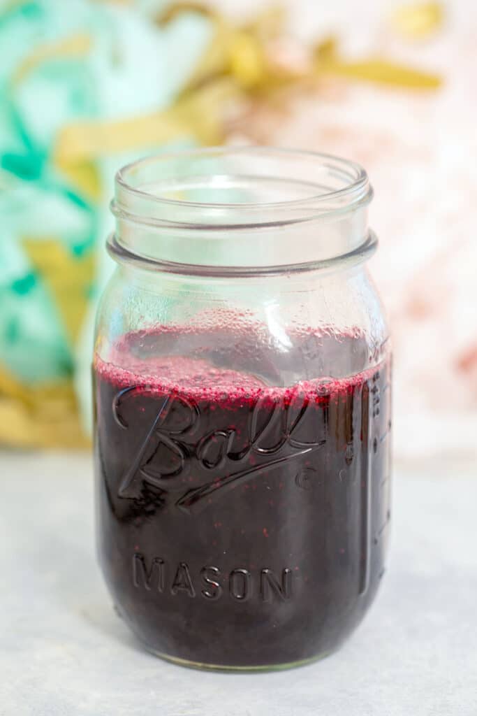 Head-on view of a jar of blueberry simple syrup
