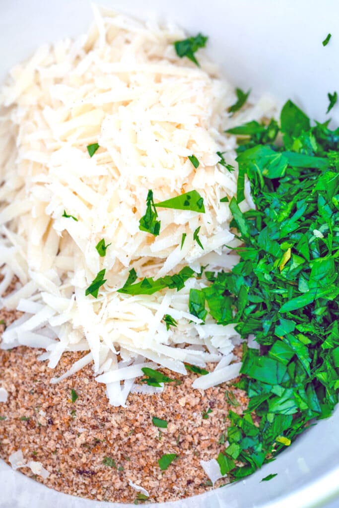Bread crumbs, parmesan, and parsley in a bowl.