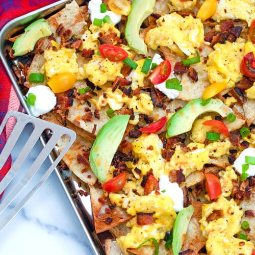 Nachos and coffee? With these Breakfast Nachos, made with pita chips, scrambled eggs, and bacon, you'll love the idea of eating nachos first thing in the morning!
