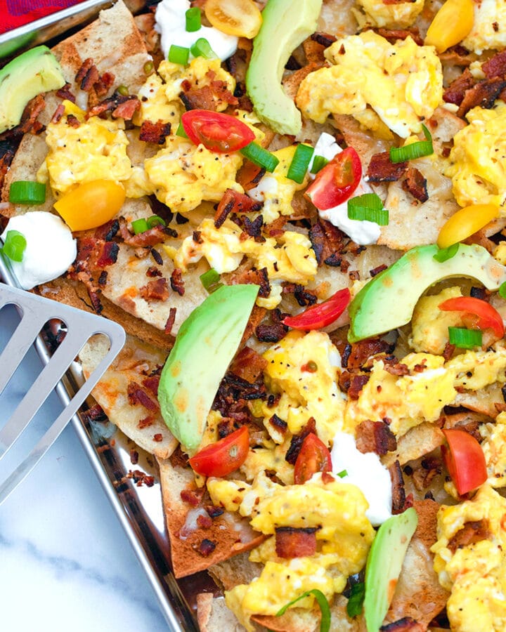 Nachos and coffee? With these Breakfast Nachos, made with pita chips, scrambled eggs, and bacon, you'll love the idea of eating nachos first thing in the morning!