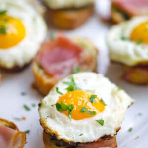 Brunch Bruschetta -- The perfect finger-food brunch dish to serve a crowd, these Brunch Bruschetta are topped with herbed garlic butter, prosciutto, and eggs | wearenotmartha.com