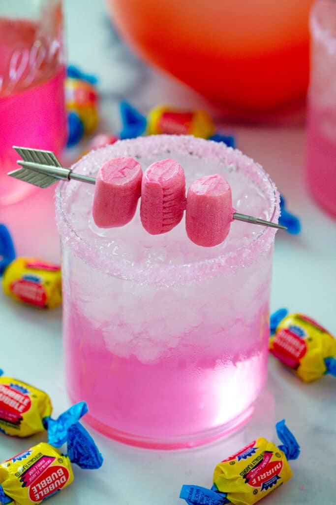 Overhead view of bubblegum cocktail with gum garnish and Double Bubble gum all around