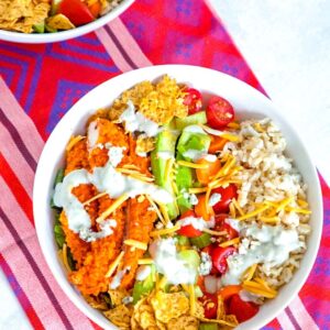 Buffalo Chicken Burrito Bowl -- This Buffalo Chicken Burrito Bowl is the ultimate salad with brown rice, avocado, carrots, celery, tomatoes, blue cheese dressing, and more. If you don't have time to make the whole entrée, you must at least make the buffalo chicken! | wearenotmartha.com