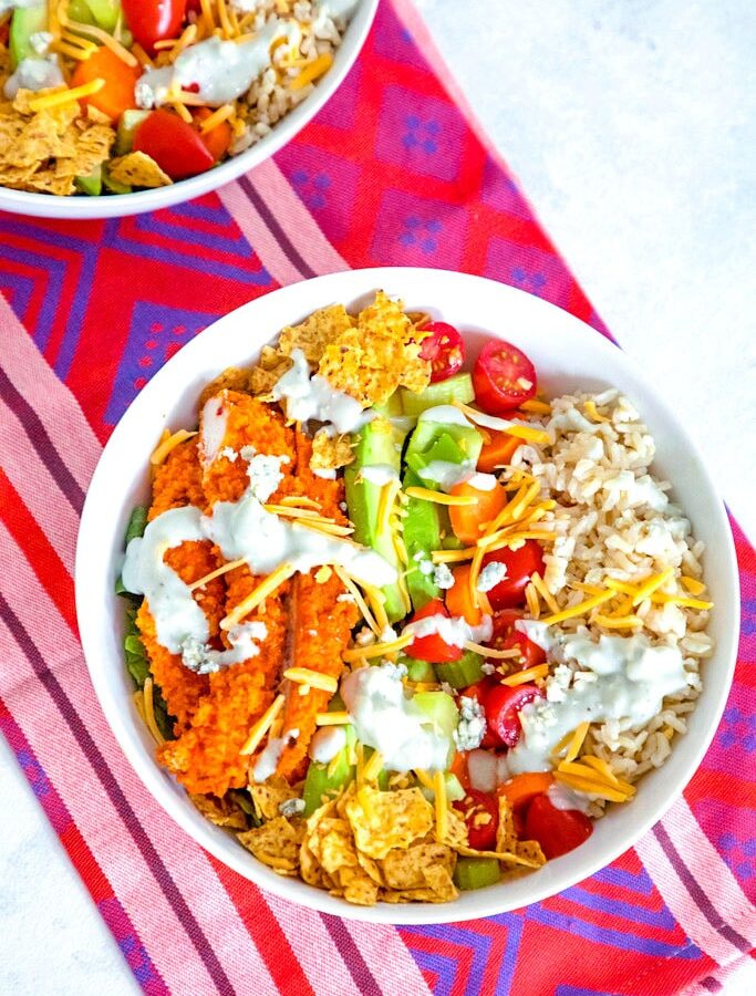 Buffalo Chicken Burrito Bowl -- This Buffalo Chicken Burrito Bowl is the ultimate salad with brown rice, avocado, carrots, celery, tomatoes, blue cheese dressing, and more. If you don't have time to make the whole entrée, you must at least make the buffalo chicken! | wearenotmartha.com