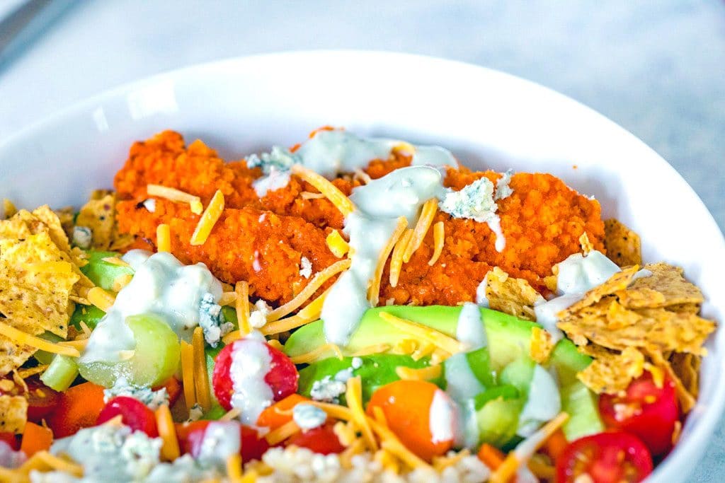 Landscape closeup view of buffalo chicken burrito bowl salad