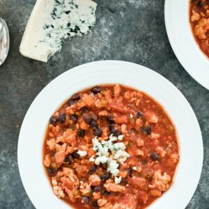 Buffalo Chicken Chili -- This chili is a hearty and flavor chili that packs the perfect amount of heat. Top with blue cheese and serve during your game day gatherings or on any day that calls for comfort food | wearenotmartha.com