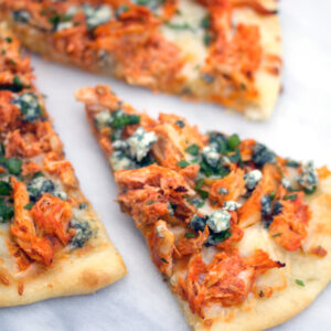 Buffalo Chicken Pizza -- If you love buffalo chicken and can't get enough pizza, you will be obsessed with this Buffalo Chicken Pizza. Make it with a rotisserie chicken for an incredibly easy weeknight dinner | wearenotmartha.com