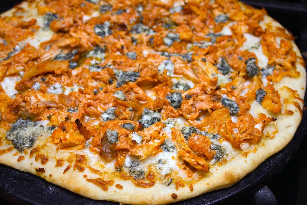 Buffalo chicken pizza on pizza pan right out of the oven