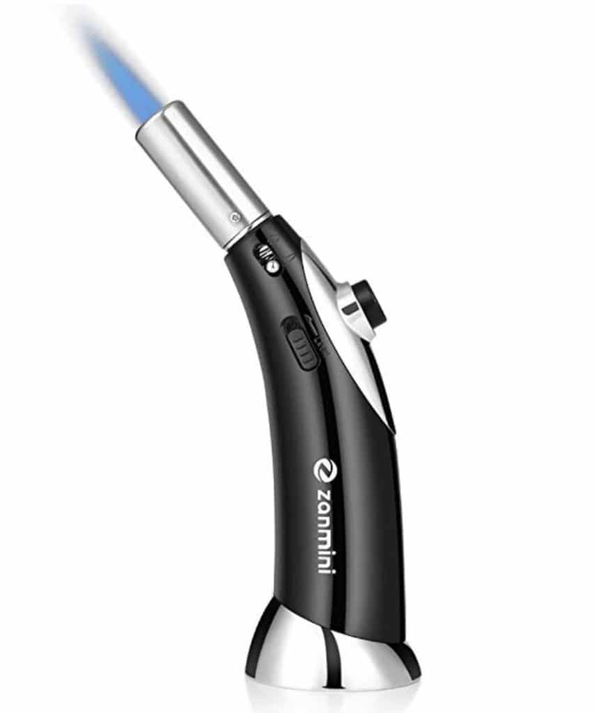 Butane cooking torch with blue flame coming out of it