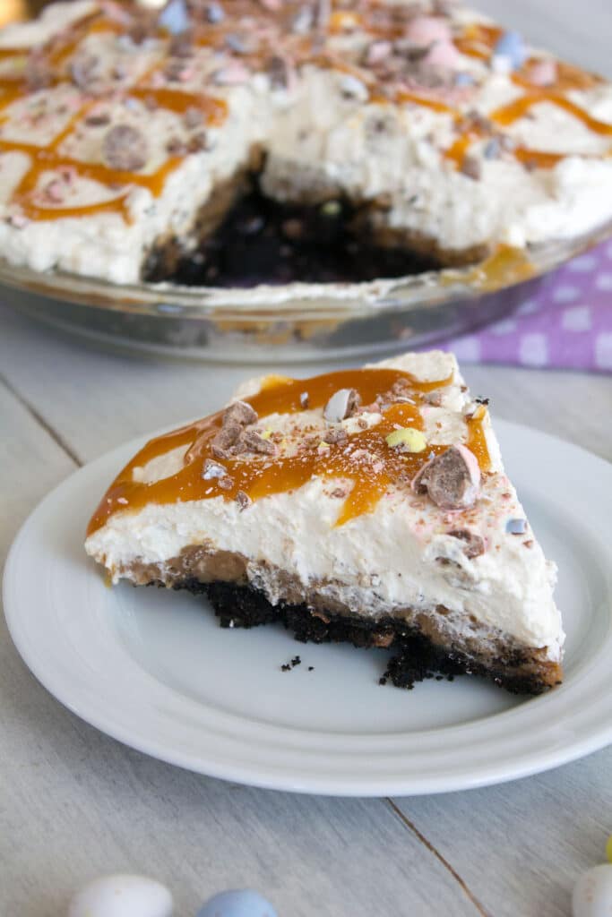 Close-up head-on view of a slice of Cadbury Egg pie with rest of the pie in the background.