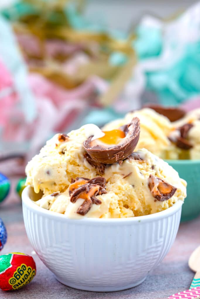 Head-on closeup view of Cadbury Creme Egg Ice Cream topped with more Cadbury Creme Eggs