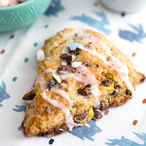 Close-up view of Cadbury Mini Egg scone with icing drizzle