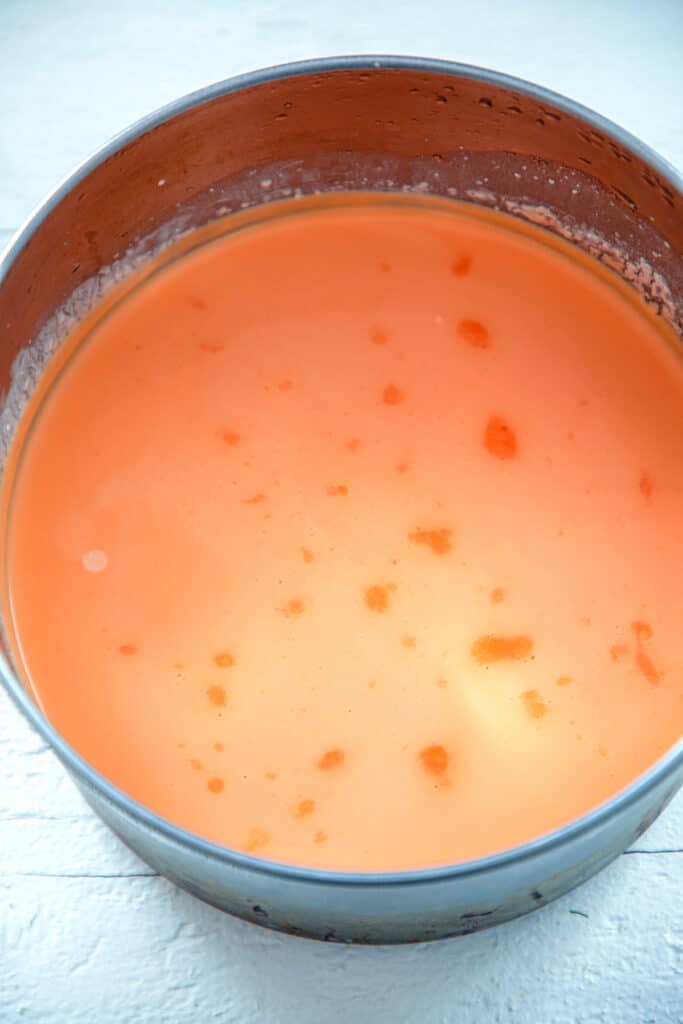 Candy corn infused milk in saucepan