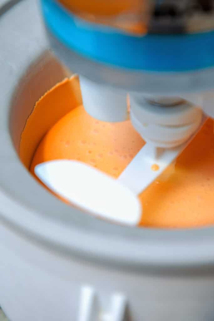 Orange candy corn ice cream based freezing in ice cream maker