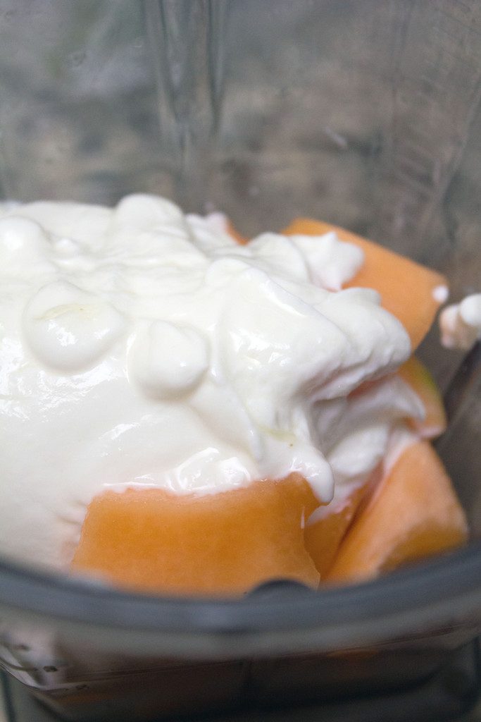 View of chopped cantaloupe and Greek yogurt in blender