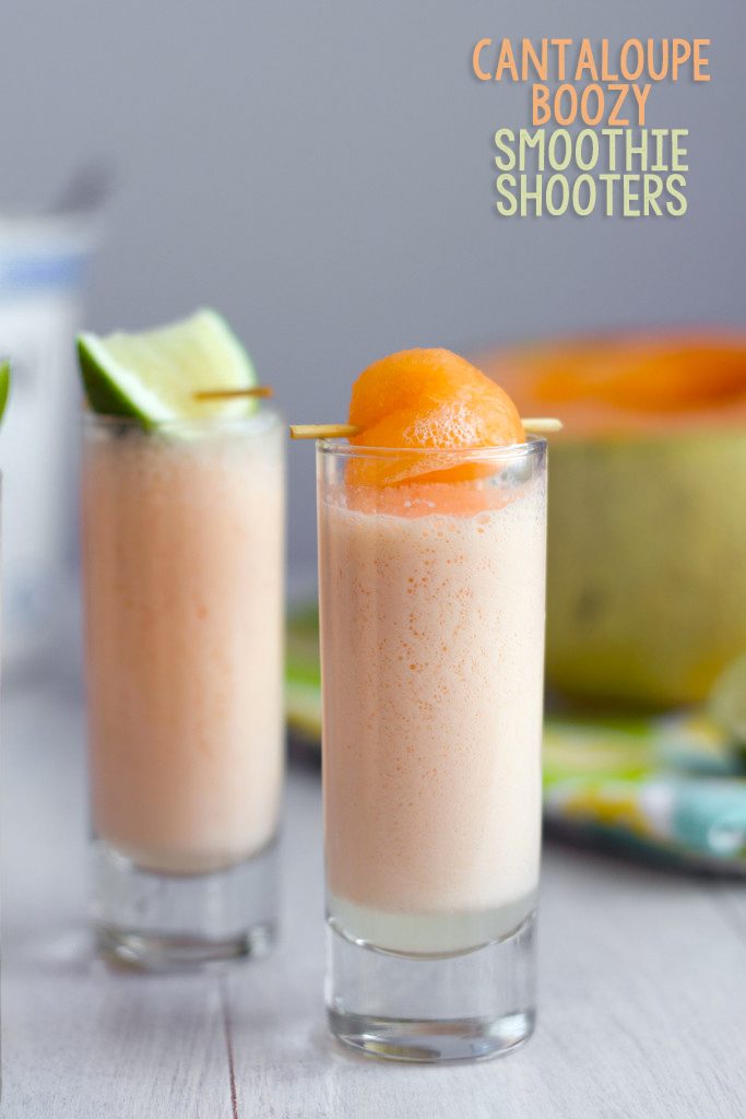 Head-on view of a cantaloupe boozy smoothie shooter with cantaloupe ball garnish with second smoothie with lime garnish and cantaloupe half in background and recipe title at top