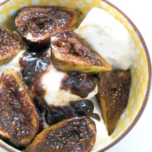 Overhead closeup view of caramelized figs over vanilla ice cream