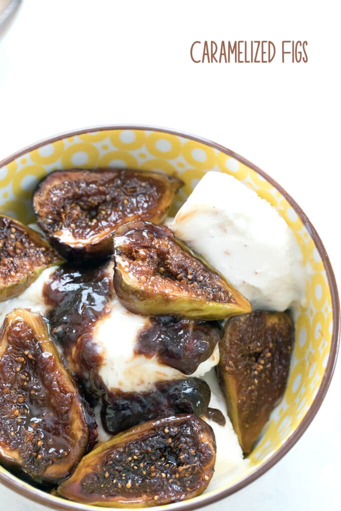 Overhead view of a yellow bowl filled with vanilla ice cream and topped with caramelized figs along with some of their juices with the recipe title at the top of the photo