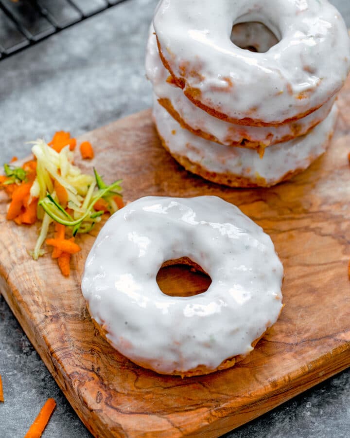 Carrot Zucchini Donuts -- Zucchini bread is great, but zucchini donuts are way more fun! These Carrot Zucchini Donuts combine two delicious vegetables into one sweet donut, glazed with vanilla Greek yogurt icing and perfect for breakfast or dessert | wearenotmartha.com #donuts #zucchinirecipes #zucchinidonuts #bakedgoods #summerdesserts